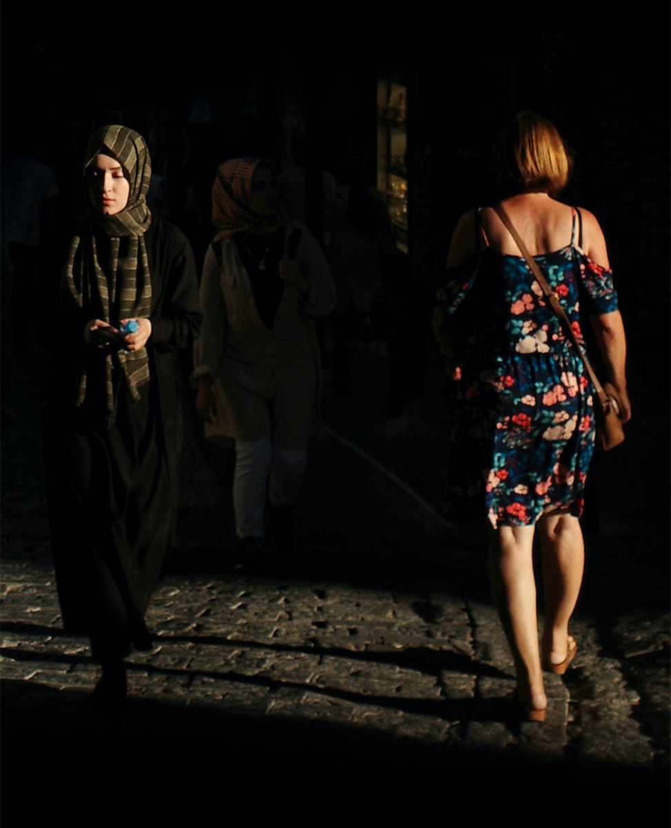Two women passing each other in the street
